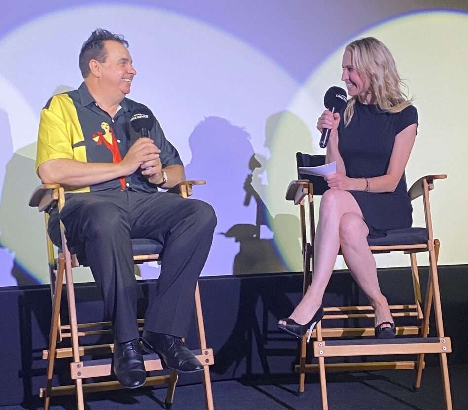 Director Sandro Monetti on stage at the LA premiere of Tech To The Future, seated beside an interviewer.